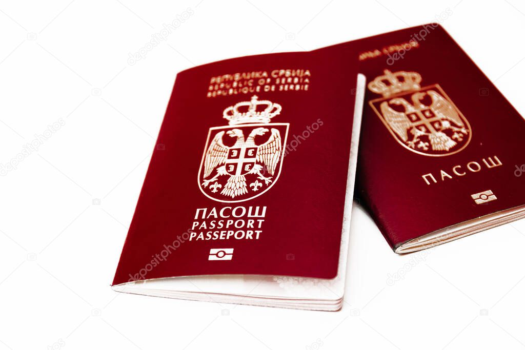 Two version of biometric Serbian passport, old and new, isolated on white background