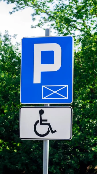 Blue sign and White Parking sign Parking for persons with disabilities