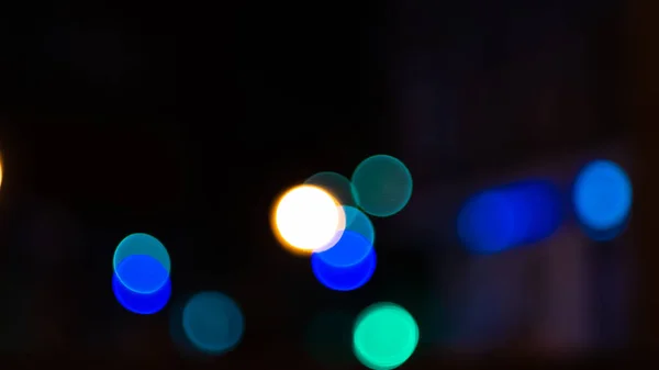 Bokeh lights on road in the city, night lights in city, street lights bokeh background, blur of night lights bokeh on street. Cinematic lens shot