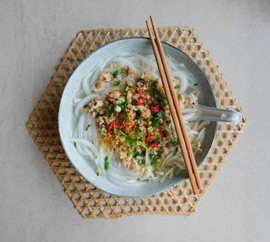 Homemade noodle soup meal. Loh Shee Fun aka Silver Needle Noodle Soup with Stir Fried Ground Pork, Bean Sprout and Preserved Turnip. A delicious savory chinese meal loved by many young and old clipart