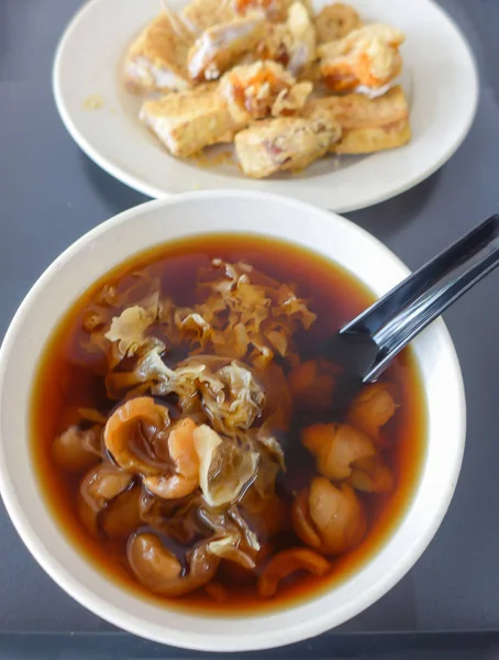 Traditional asian sweet herbal soup in white bowl