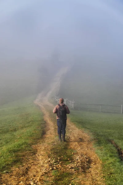 tourist in the mountains. photographer takes a sunrise in the mountains