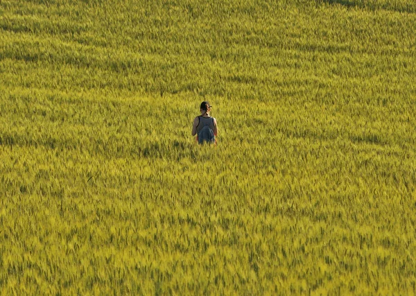 girl in the field. hilly spring field. tourist meditates in the field. Alone with nature