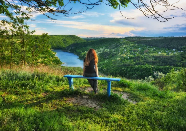 tourist on the rock. girl meditates on nature. canyon of the picturesque river