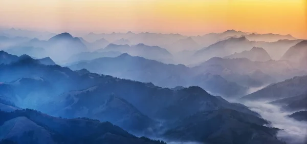 高地での夜明け前の時間 霧の中の山のシルエット — ストック写真