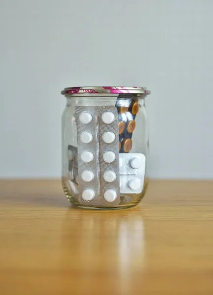 many pills and medicines in a glass jar