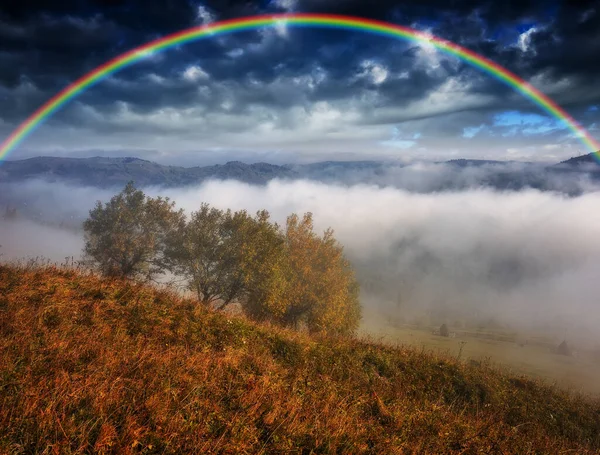 Rainbow over the Mountains. autumn morning in the Carpathians