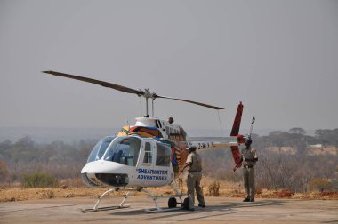 o yer ekibi Bell 206 l-3 Longranger helikopter uçuş için hazırlanıyor