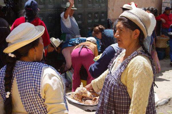 ecuadorian women walking in the food market of Cuenca
