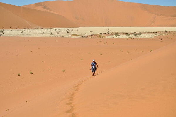 Adult woman walking in Sossusvlei, Namibia