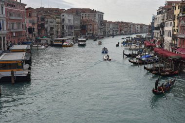view on canal of Venice with boat and people clipart