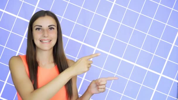 Girl Pointing with Finger on Side, Blue Background. — Stock Video