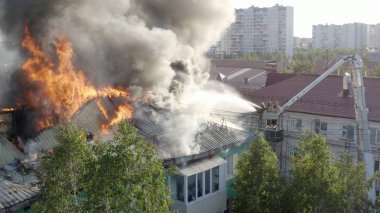 Nizhnevartovsk, Rusya - 1 Temmuz 2019: İtfaiyeciler yüksek katlı bir binanın çatısında çıkan yangını söndürdü