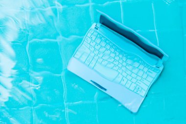 Havuzun dibindeki mini bilgisayar. İş yerinde bir sürü iş kavramı. Bulanıklaştırma soyut arka plan.