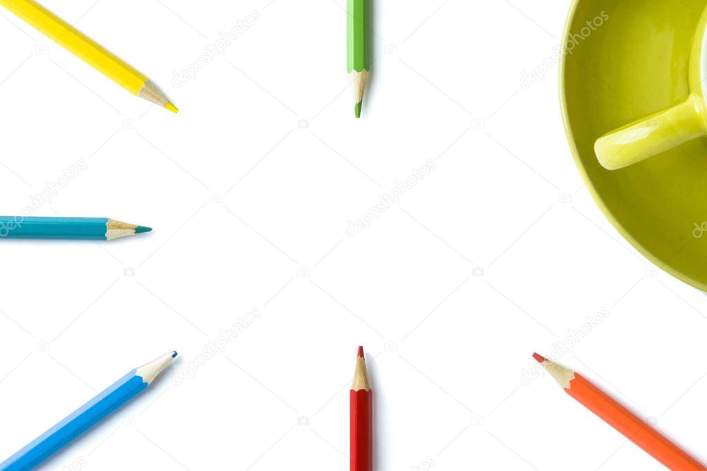 colored pencils and part of a mug on an isolated white background. Copy space.