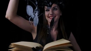 Büyü, gülümsüyor, mekanik örümcekler ve örümcek ağları yardımıyla conjures açık bir kitap ile parlak kırmızı dudakları ile Çekici kadın cadı.
