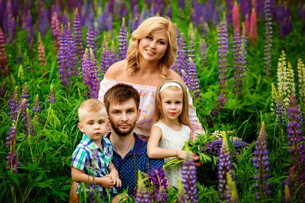 Mother Daughter Clearing Lupine Flowers Field Mother Holding Small Dog — Stock Photo, Image