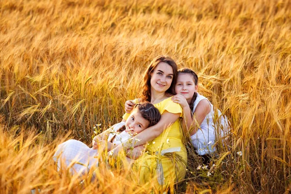 Pregnant Woman Yellow Dress Two Daughters White Sundresses Sit Hugging — Stock Photo, Image