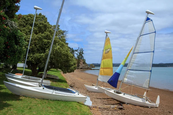 Sailing catamarans for hire on the beach in Russell, a holiday town in the beautiful Bay of Islands, New Zealand