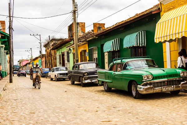 特立尼达和多巴哥 2019 古巴骑自行车和旧汽车停在五颜六色的房子前 在联合国教科文组织世界遗产老城区 — 图库照片