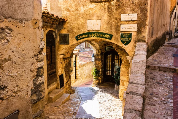 Narrow alley and old stone houses in Eze village in France.