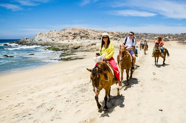 Cabo San Lucas, Mexico - 2019. Tourists horseback riding on the beach in Cabo San Lucas, Baja California. — Stock Photo, Image