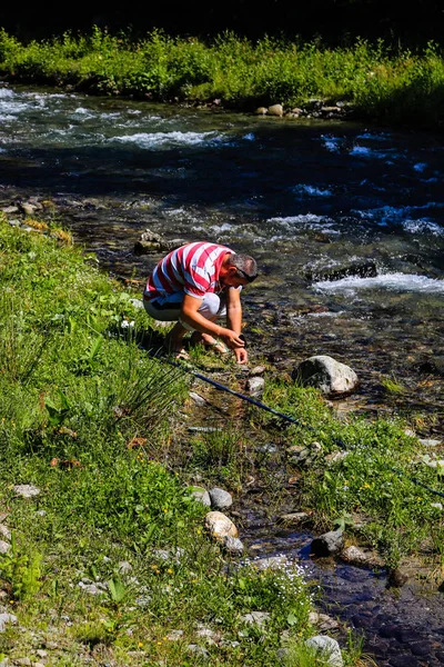 Iezer Mountains - Romania - 2019. Man preparing his bate for fis — Stock Photo, Image