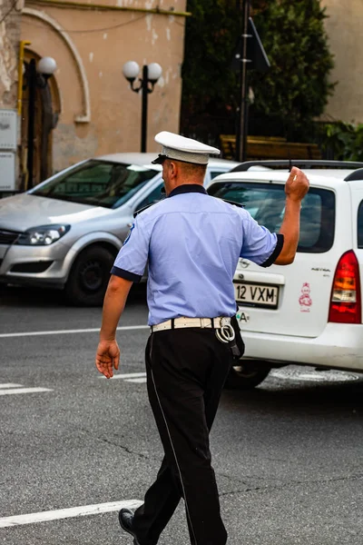 Local police man on duty directing traffic on a national holiday — Stock Photo, Image