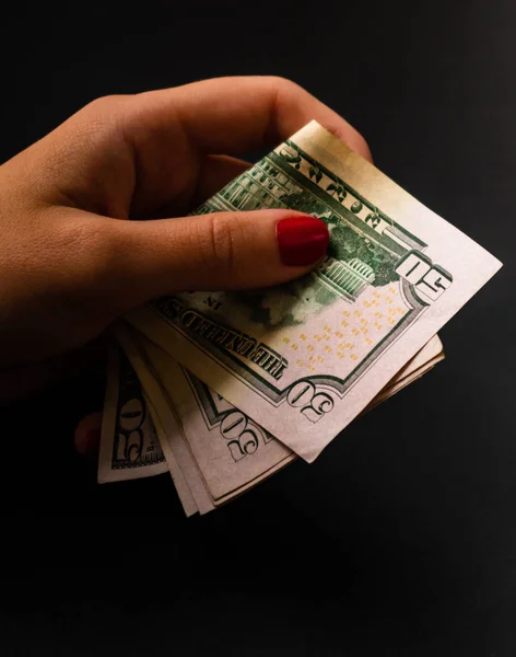 Woman counting money, counting dollars close up