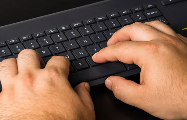 Male hand using pc keyboard. Close up man hand on computer keybo