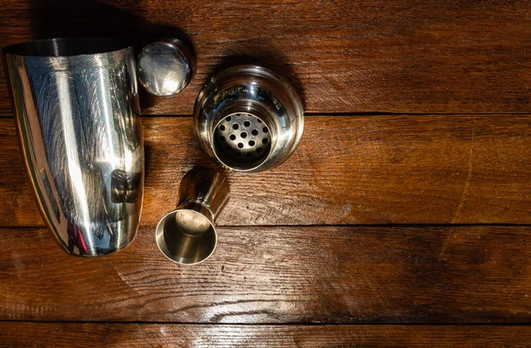 Accesorios coctelera y vasos de chupito en una tabla de madera . —  Fotos de Stock