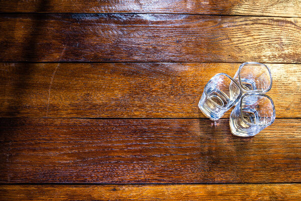 Shot glasses on wooden board. Bar ustensils, drink concept.
