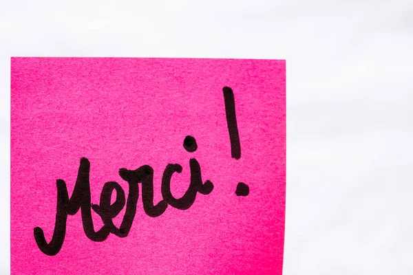 Merci Handwriting Text Close Isolated Pink Paper Copy Space Writing — Stock Photo, Image