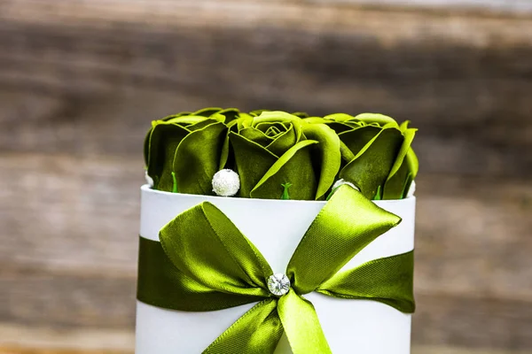 Green roses in a round luxury present box. Bouquet of flowers in a paper box isolated.