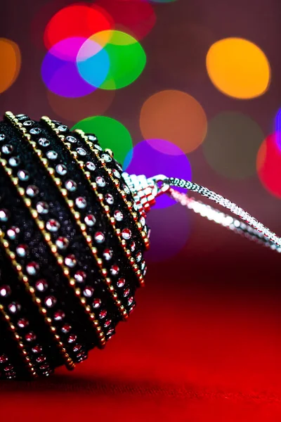 Black Shiny Christmas Ball Bauble Christmas Composition Blurred Lights Background — Stock Photo, Image