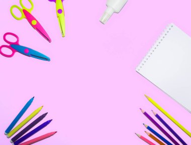 renkli kalemler, Not defteri ve makas izole bir pembe arka plan düz bir yüzeye kaplı düz yatıyordu resmi