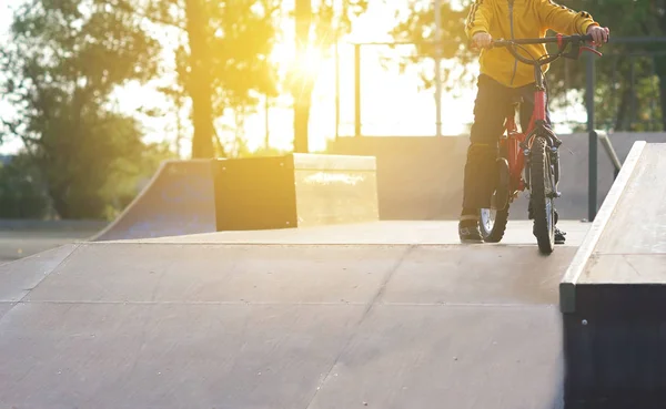 스포츠 자전거에가 일몰에 태양에 슬로프를 스케이트 공원에 배운다 — 스톡 사진