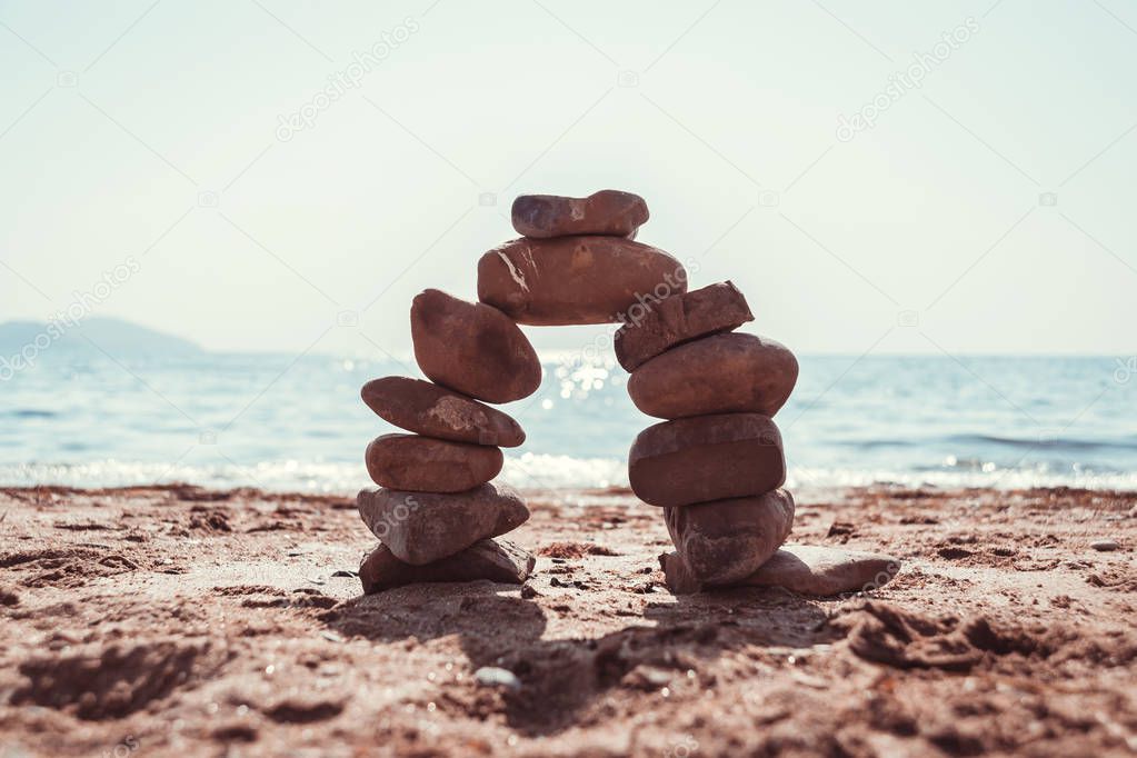 Arch of stones on the sea summer beach.