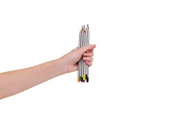 Жінки рука тримає кольорові олівці ізольовані на білому тлі . — стокове фото