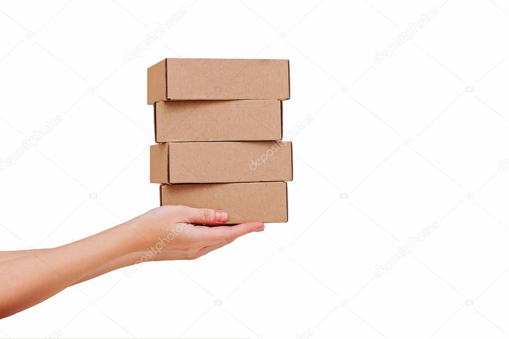 Womans hands holding boxes stacked on white isolated background. Mock up.