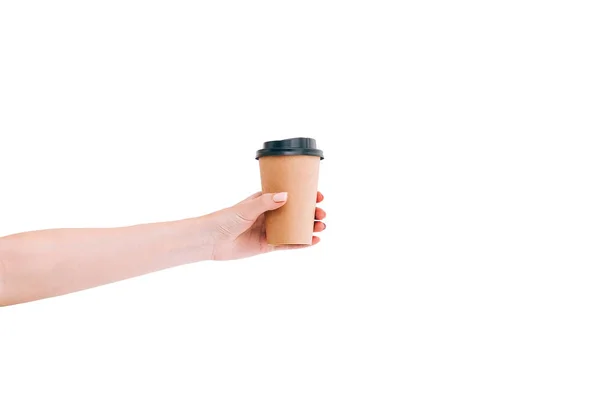 Paper coffee cup to go in womans hand isolated on white. Mockup.