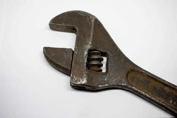 Old, rusty adjustable wrench on a white background close-up. — Stock Photo, Image