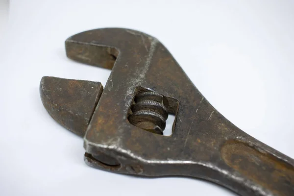 Old, rusty adjustable wrench on a white background close-up. — Stock Photo, Image