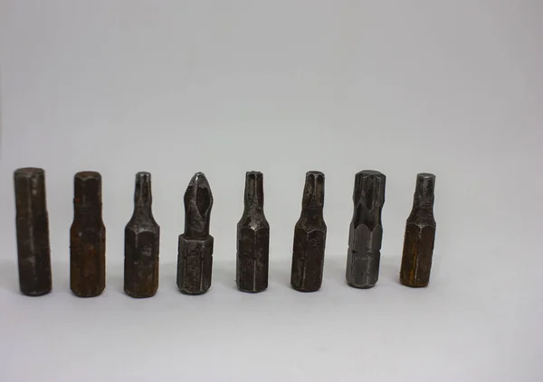 Old, rusty screwdriver bits on a white background. Close-up. — Stock Photo, Image