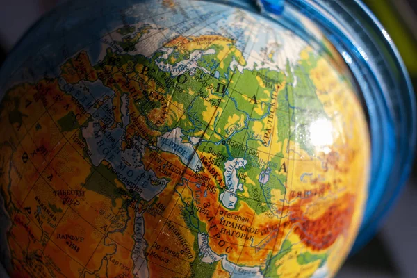 Globe with Russian letters with the focus on Europe close-up.