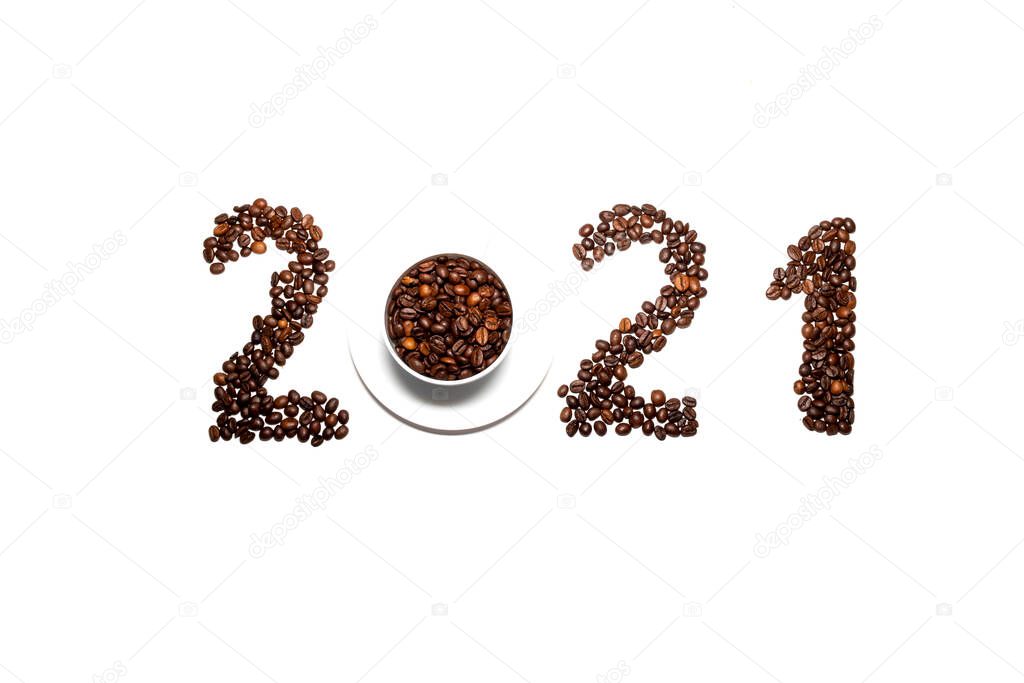 The year 2021 is lined with coffee beans on a white background. concept of christmas coffee shop with top view.