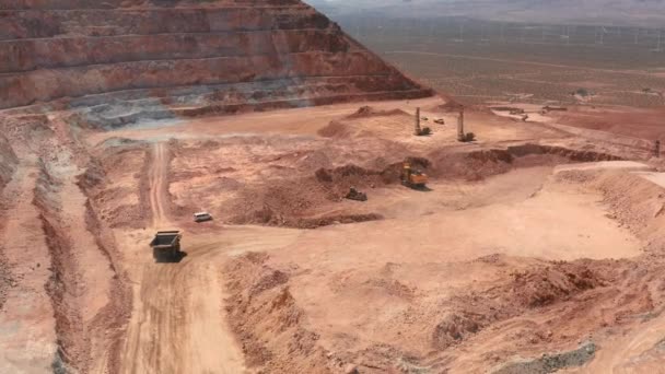 Paysages industriels, États-Unis. Caméra suit un camion benne conduisant par la route poussiéreuse — Video