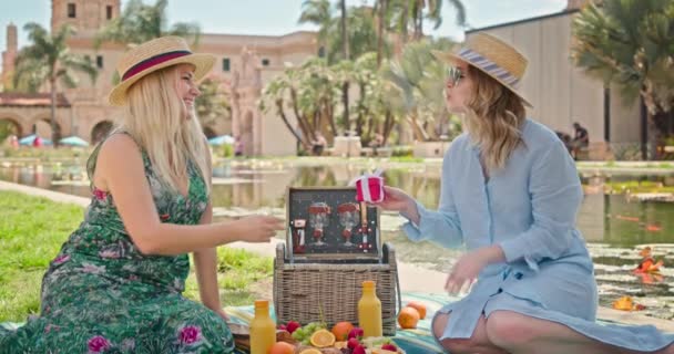 Happy amazed young caucasian young woman receiving and opening red box with gift — Stock Video