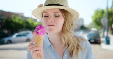 Gülümseyen kadın külahta lezzetli dondurma yiyor, arkadaşına el sallıyor ve