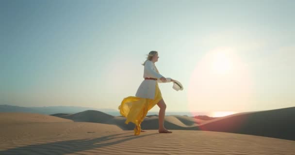 Lycklig kvinna vid solnedgången. Slow motion 4K vacker modell dans på sanddyner — Stockvideo